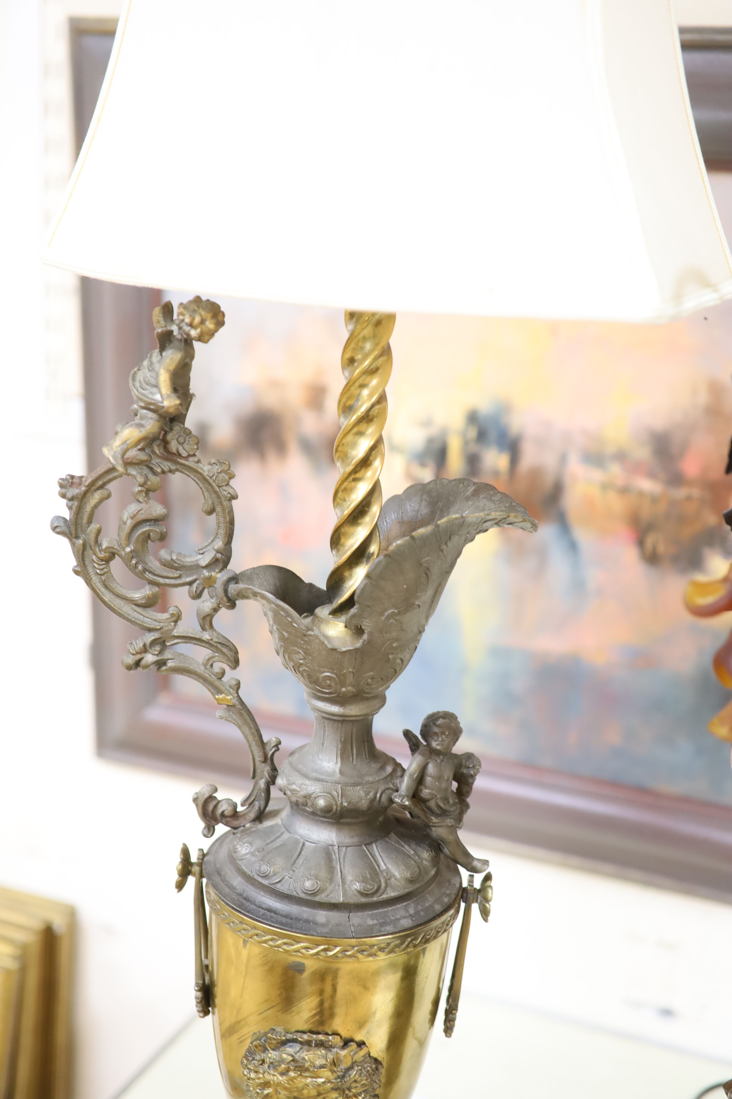 A Florentine style brass, spelter and onyx ewer shaped table lamp and a bronzed spelter figural table lamp with glass shades